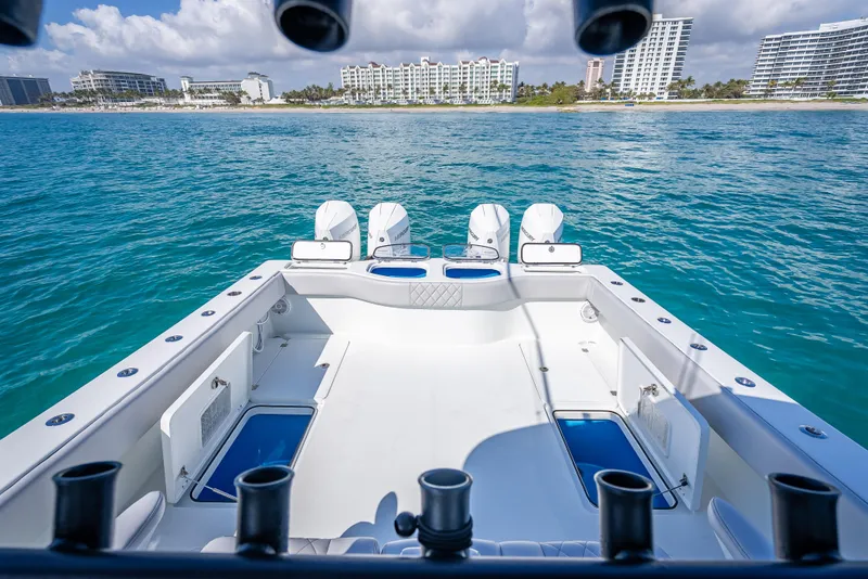Slide: The Image of Freeman 42 LR 2019 boat with four engines, ocean view, and city skyline in the background. - 28