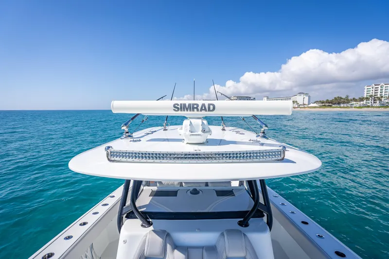 Slide: The Image of Freeman 42 LR boat, 2019 model, equipped with Simrad technology, cruising on clear blue waters. - 29