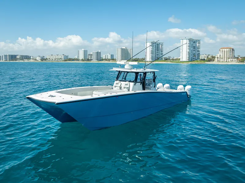 Slide: The Image of 2019 Freeman 42 LR boat on blue water with city skyline in background. - 3