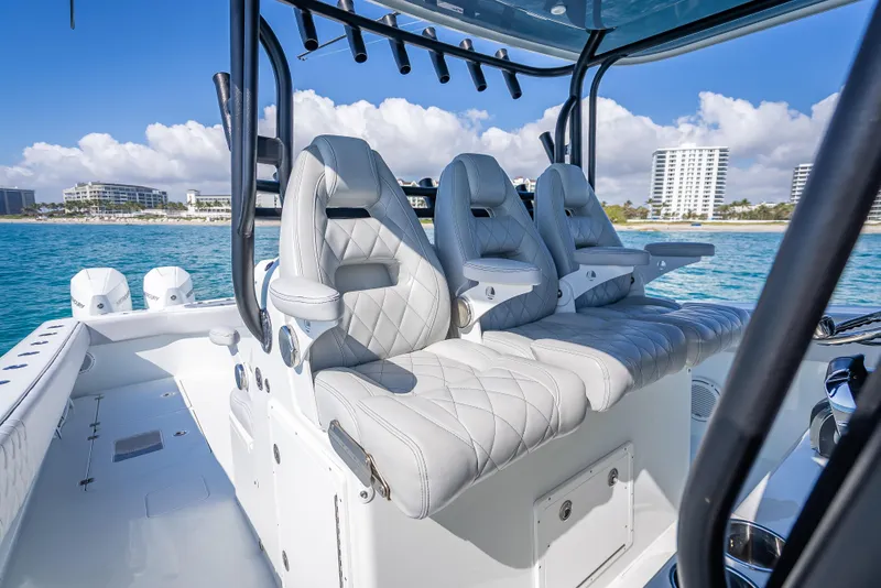 Slide: The Image of Luxurious seating on a 2019 Freeman 42 LR boat with ocean and cityscape backdrop. - 33