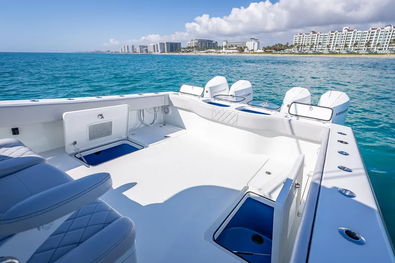 Slide: The Image of 2019 Freeman 42 LR boat on clear blue water near a coastal cityscape. - 34