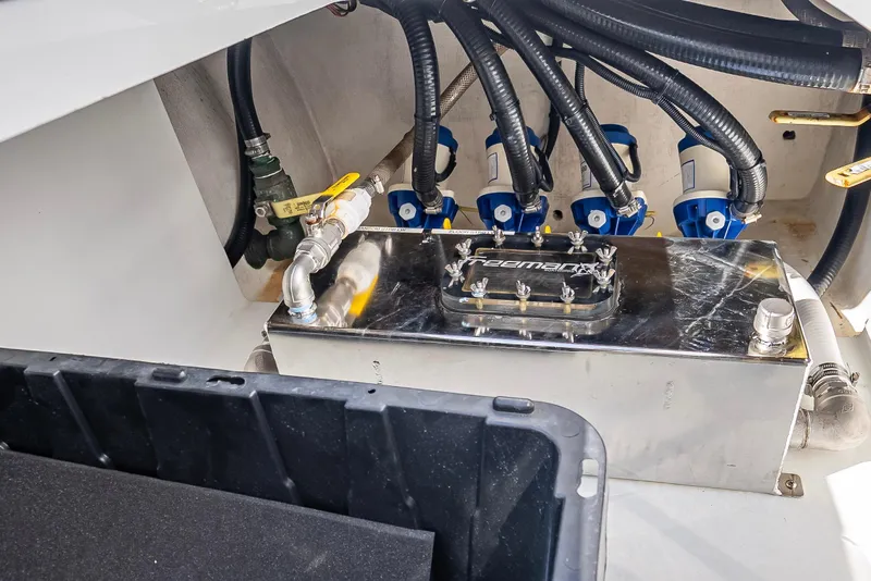 Slide: The Image of Engine compartment of a 2019 Freeman 42 LR boat with visible hoses and components. - 36