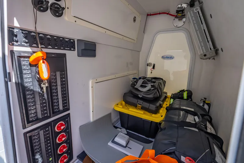 Slide: The Image of Interior of a 2019 Freeman 42 LR boat with storage and control panels. - 39
