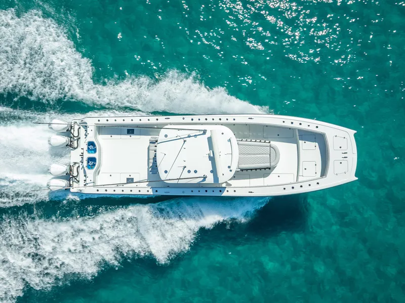 Slide: The Image of Aerial view of 2019 Freeman 42 LR boat cruising on clear turquoise water. - 7