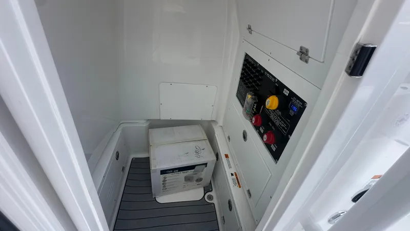 Slide: The Image of Interior view of 2025 Caymas 26 HB boat's control panel and storage area. - 10