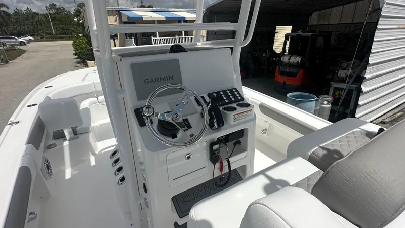 Slide: The Image of 2025 Caymas 26 HB boat cockpit with Garmin navigation system and modern controls. - 11