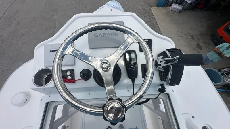 Slide: The Image of 2025 Caymas 26 HB boat helm with Garmin navigation and Mercury controls. - 12