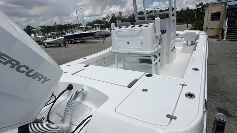 Slide: The Image of 2025 Caymas 26 HB boat with Mercury engine, docked in a marina. - 4