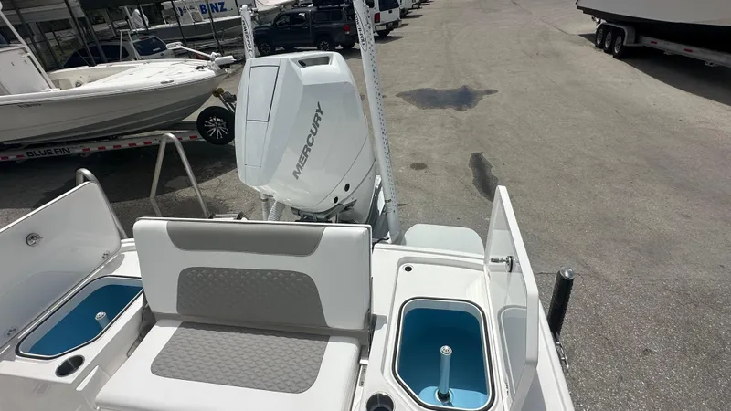 Slide: The Image of 2025 Caymas 26 HB boat with Mercury engine, featuring seating and storage compartments. - 8