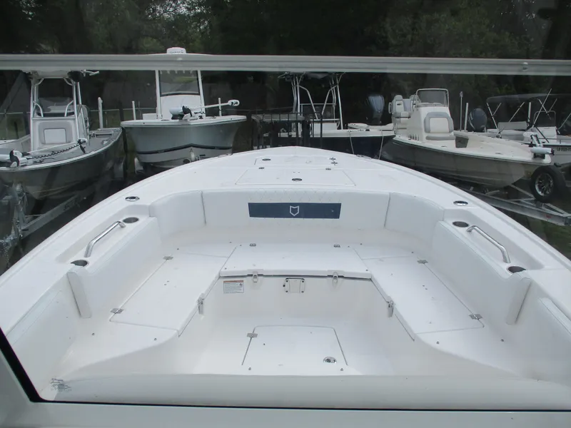 Slide: The Image of 2025 Sea Fox 282 Hybrid LT boat, spacious deck, surrounded by other boats in a marina. - 10