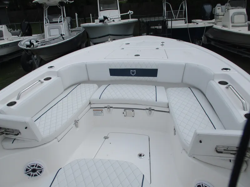 Slide: The Image of 2025 Sea Fox 282 Hybrid LT boat interior with white cushioned seating and storage compartments. - 11