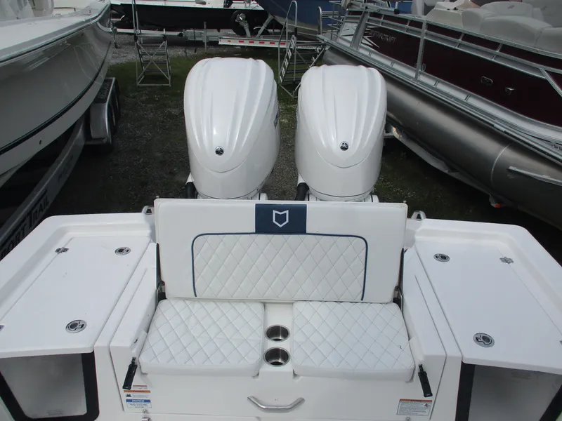 Slide: The Image of 2025 Sea Fox 282 Hybrid LT boat with dual outboard engines and cushioned seating. - 6