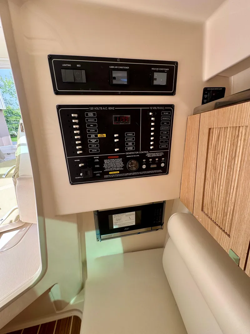 Slide: The Image of Control panel inside 2025 Grady-White 345 boat, featuring modern navigation and system controls. - 10