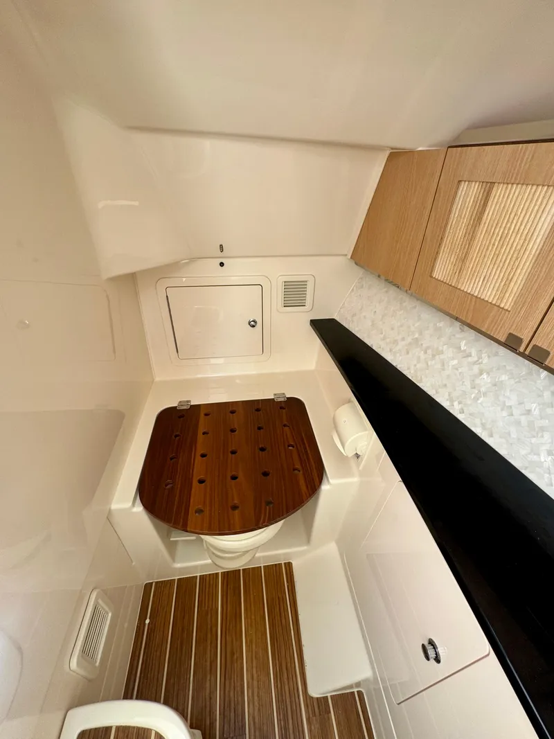 Slide: The Image of 2025 Grady-White 345 boat interior with modern wood and white finishes. - 11