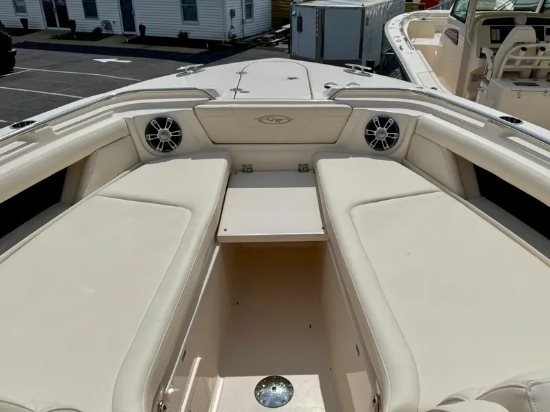 Slide: The Image of 2025 Grady-White 345 boat interior with beige seating and speakers. - 13