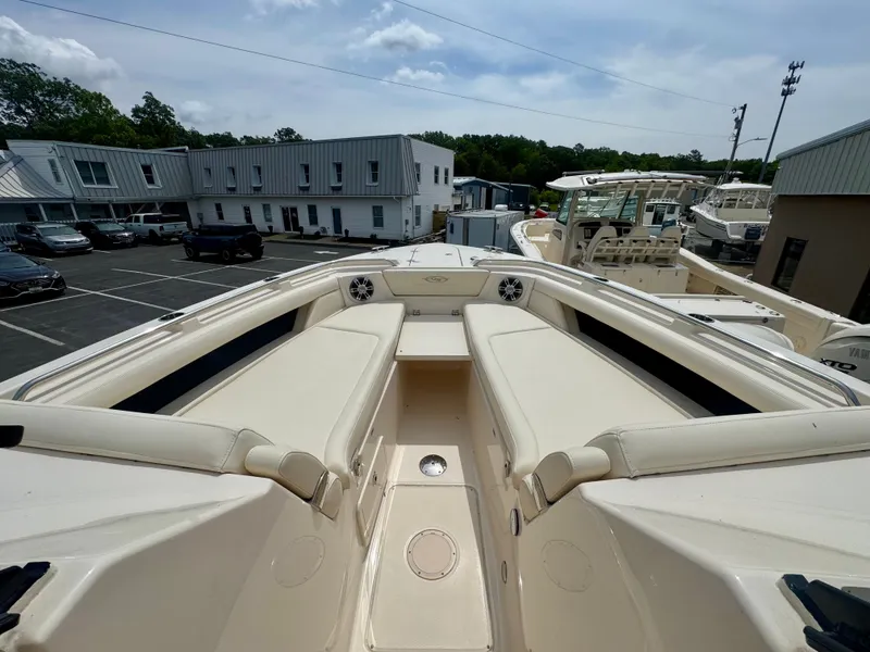 Slide: The Image of 2025 Grady-White 345 boat with spacious seating, docked in a marina. - 18