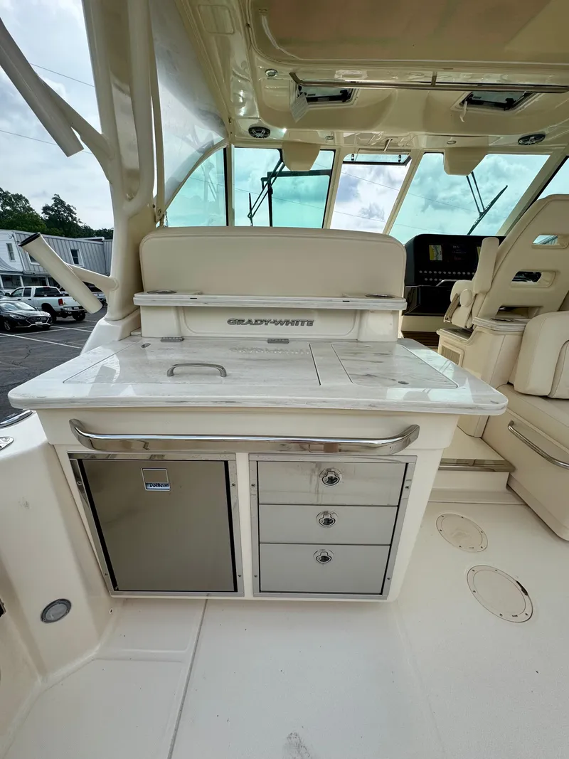 Slide: The Image of 2025 Grady-White 345 boat interior with kitchenette and seating area. - 3