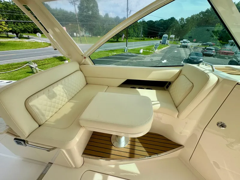 Slide: The Image of Luxurious seating area on 2025 Grady-White 345 boat with beige upholstery and wooden flooring. - 6