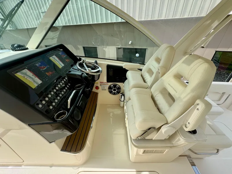 Slide: The Image of 2025 Grady-White 345 boat interior with dual helm seats and advanced navigation system. - 7