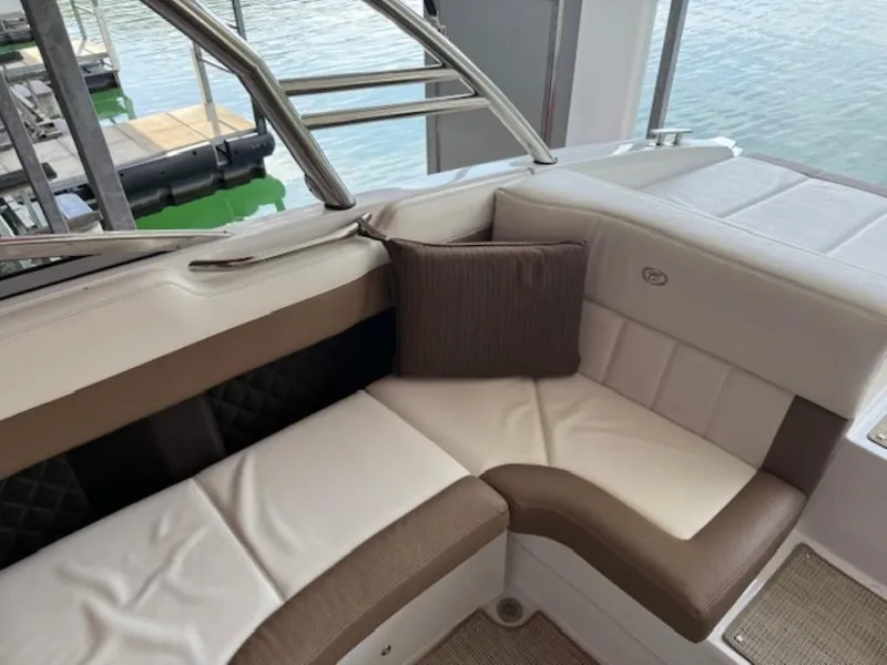 Slide: The Image of Luxury seating on a 2016 Cobalt 296 boat, docked by the water. - 10
