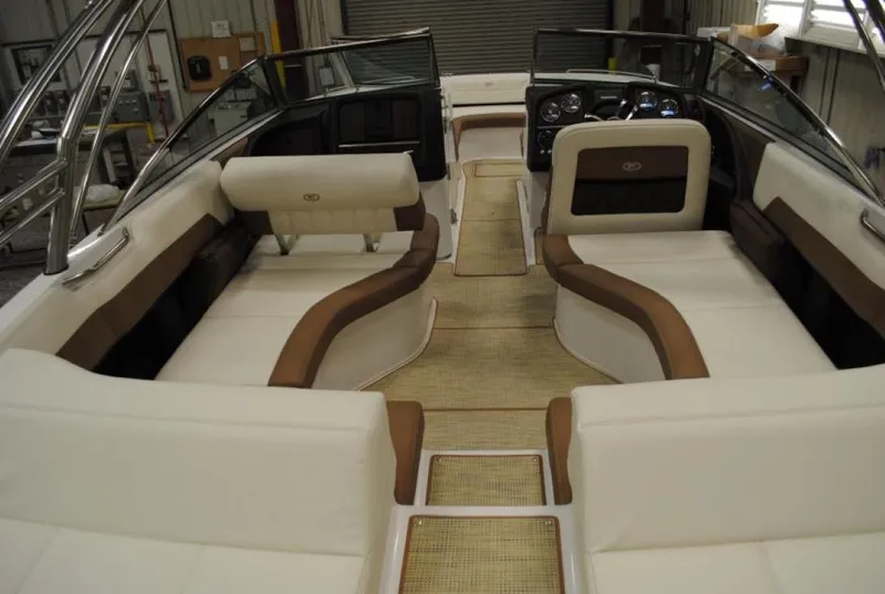 Slide: The Image of 2016 Cobalt 296 boat interior with beige and brown seating, spacious layout, and modern design. - 15