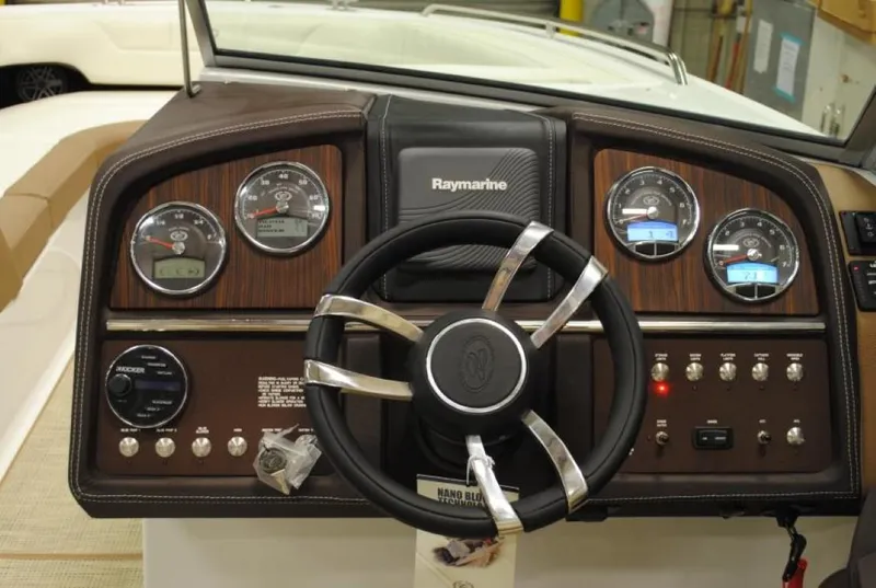 Slide: The Image of Steering wheel and dashboard of 2016 Cobalt 296 boat with gauges and controls. - 16