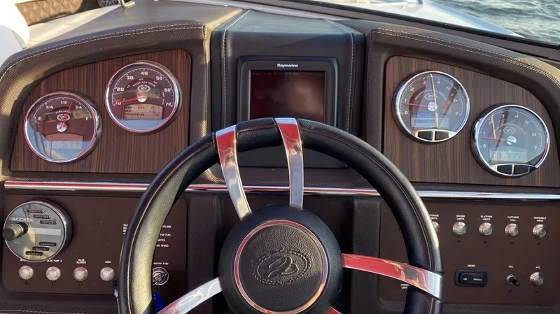Slide: The Image of Steering wheel and dashboard of a 2016 Cobalt 296 boat with gauges and controls. - 6