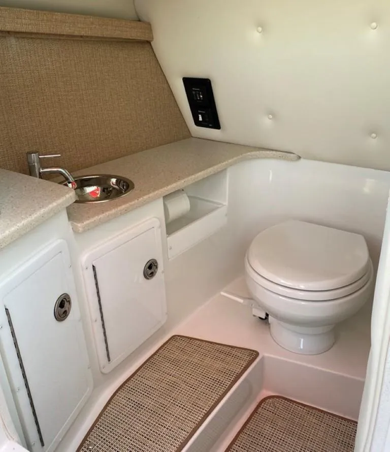 Slide: The Image of 2016 Cobalt 296 boat bathroom with sink, toilet, and storage cabinets. - 8