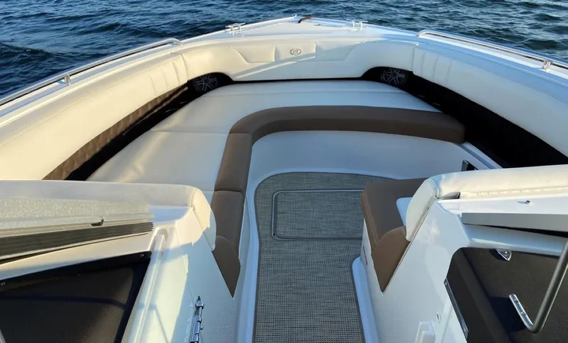 Slide: The Image of 2016 Cobalt 296 boat interior with cushioned seating, on calm water. - 9