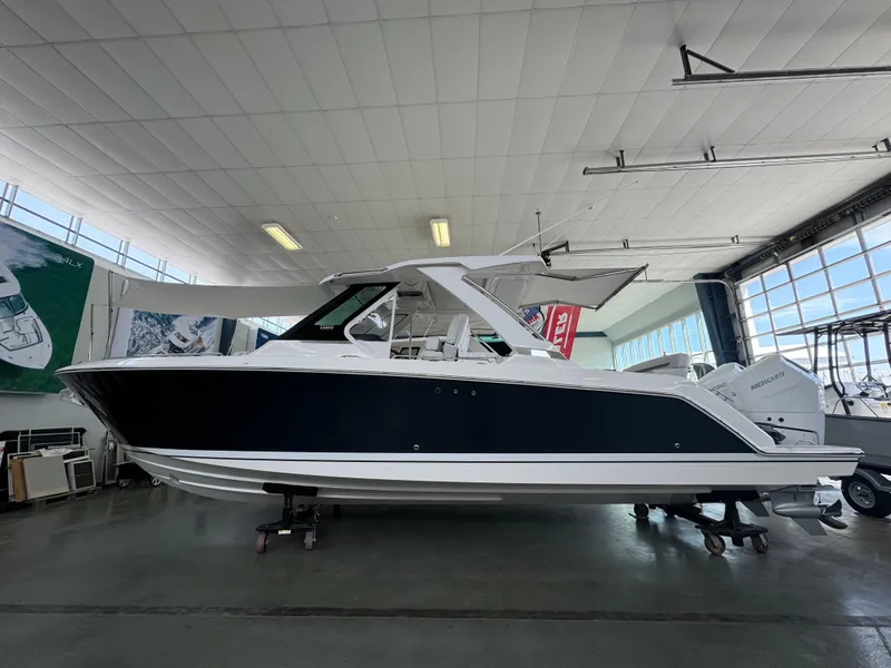 Slide: The Image of 2025 Tiara Yachts 34 LS in showroom, side view, sleek design, modern features. - 0