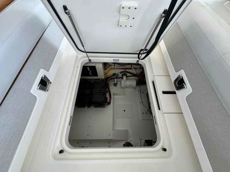 Slide: The Image of Open hatch of 2025 Tiara Yachts 34 LS, revealing interior storage compartment. - 11