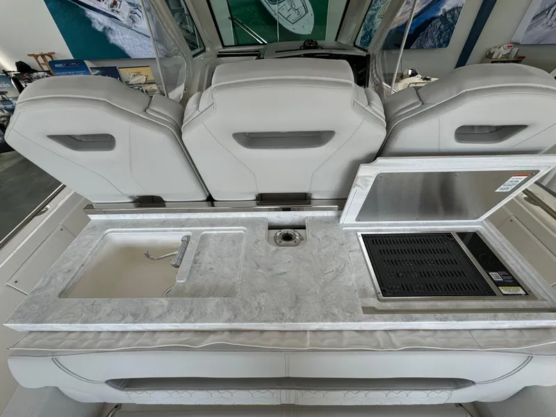 Slide: The Image of 2025 Tiara Yachts 34 LS boat interior with sleek countertop and built-in sink. - 15