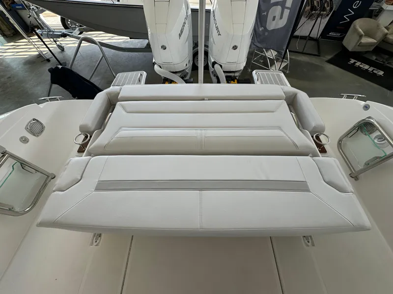 Slide: The Image of 2025 Tiara Yachts 34 LS boat interior with luxurious seating and dual outboard engines. - 16