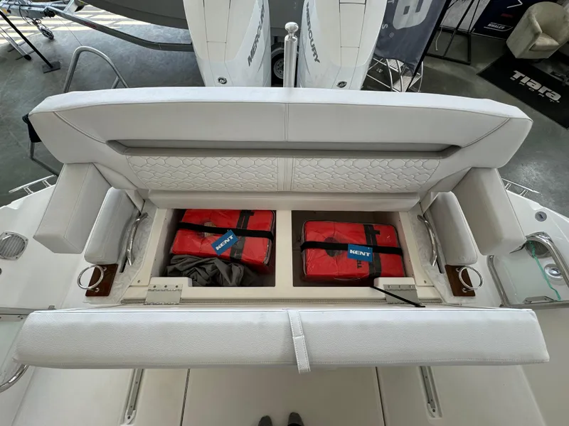 Slide: The Image of 2025 Tiara Yachts 34 LS seating with storage, featuring red life jackets. - 17