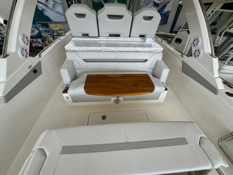 Slide: The Image of 2025 Tiara Yachts 34 LS interior with white seating and wooden table. - 18