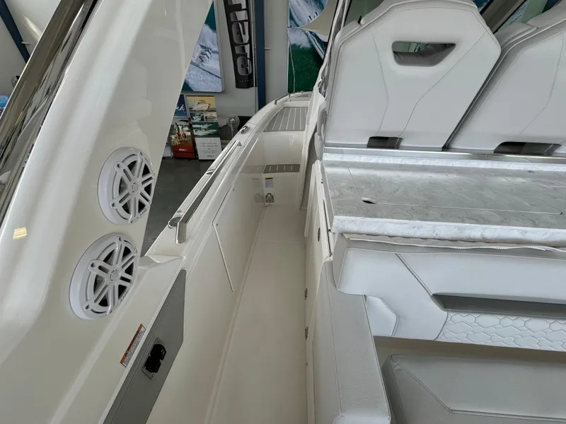 Slide: The Image of 2025 Tiara Yachts 34 LS interior with white seating and built-in speakers. - 21