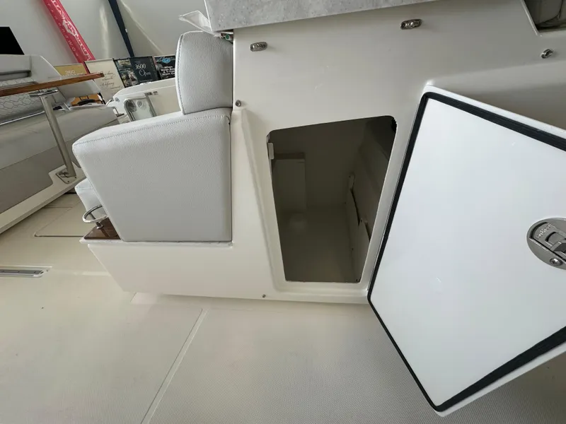 Slide: The Image of 2025 Tiara Yachts 34 LS interior storage compartment with open door, showcasing modern design. - 23