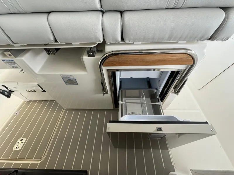 Slide: The Image of 2025 Tiara Yachts 34 LS interior with open storage compartment and sleek design. - 27