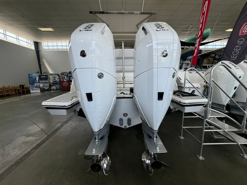 Slide: The Image of 2025 Tiara Yachts 34 LS with dual outboard engines in showroom display. - 3