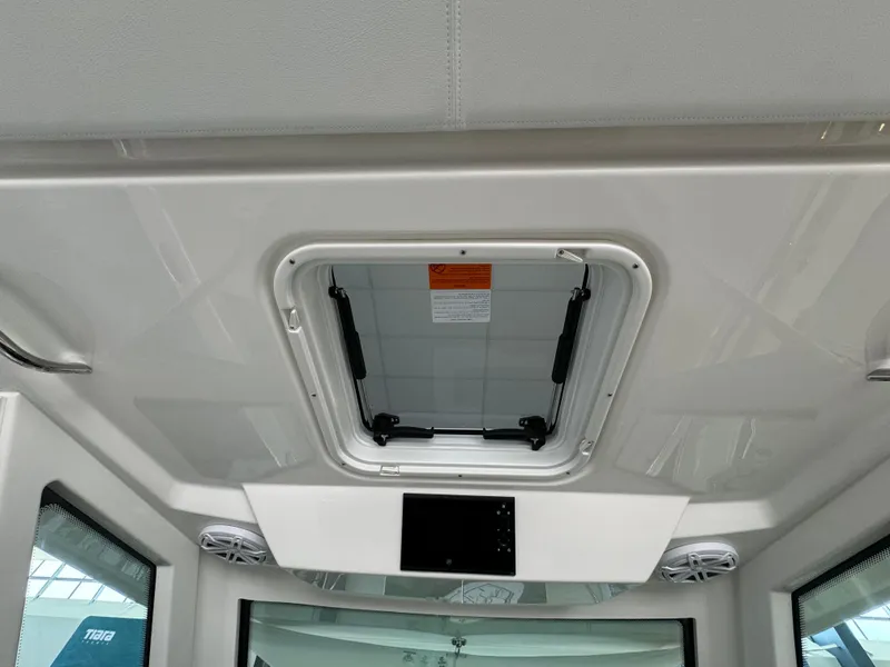 Slide: The Image of 2025 Tiara Yachts 34 LS cabin interior with ceiling hatch and speakers. - 32