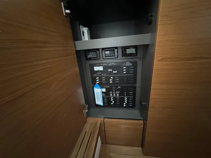 Slide: The Image of Electrical panel inside 2025 Tiara Yachts 34 LS, featuring modern wooden cabinetry. - 33