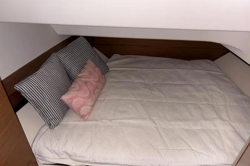 Slide: The Image of Cozy cabin bed in 2025 Tiara Yachts 34 LS with patterned pillows. - 35