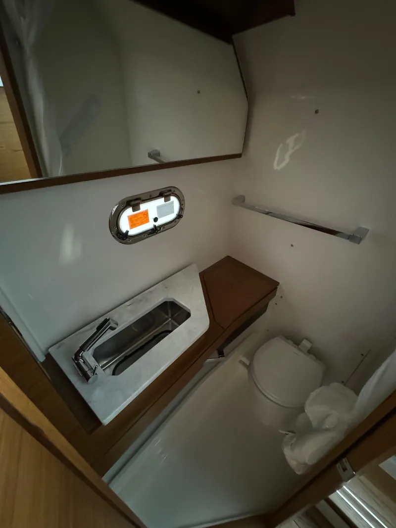 Slide: The Image of 2025 Tiara Yachts 34 LS bathroom interior with modern fixtures and compact design. - 36