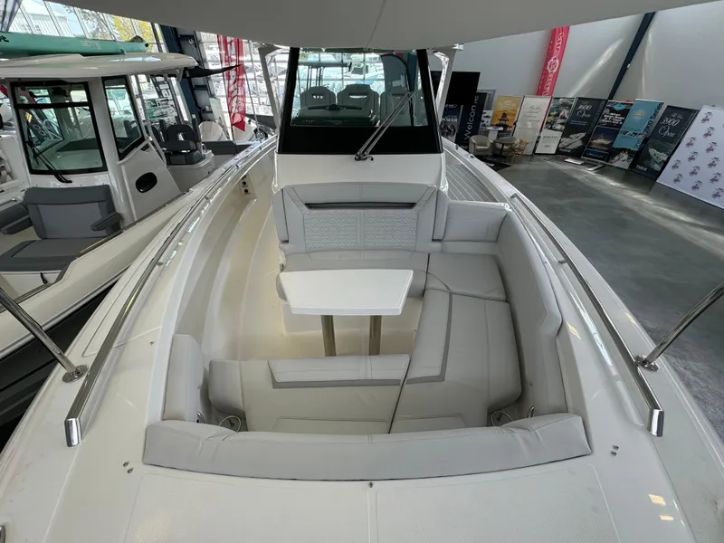 Slide: The Image of 2025 Tiara Yachts 34 LS boat interior with seating and table in showroom. - 37
