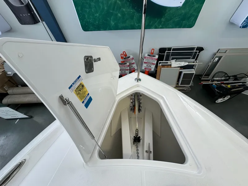 Slide: The Image of Open anchor locker on 2025 Tiara Yachts 34 LS, showcasing storage and chain mechanism. - 43