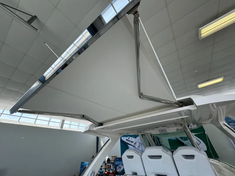 Slide: The Image of 2025 Tiara Yachts 34 LS with retractable canopy in showroom. - 7