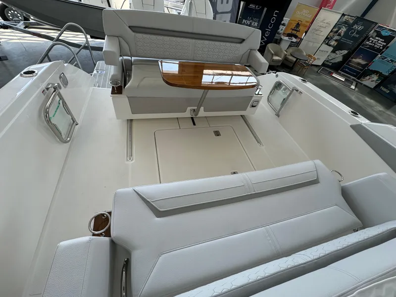 Slide: The Image of 2025 Tiara Yachts 34 LS interior with sleek seating and elegant wooden table. - 9