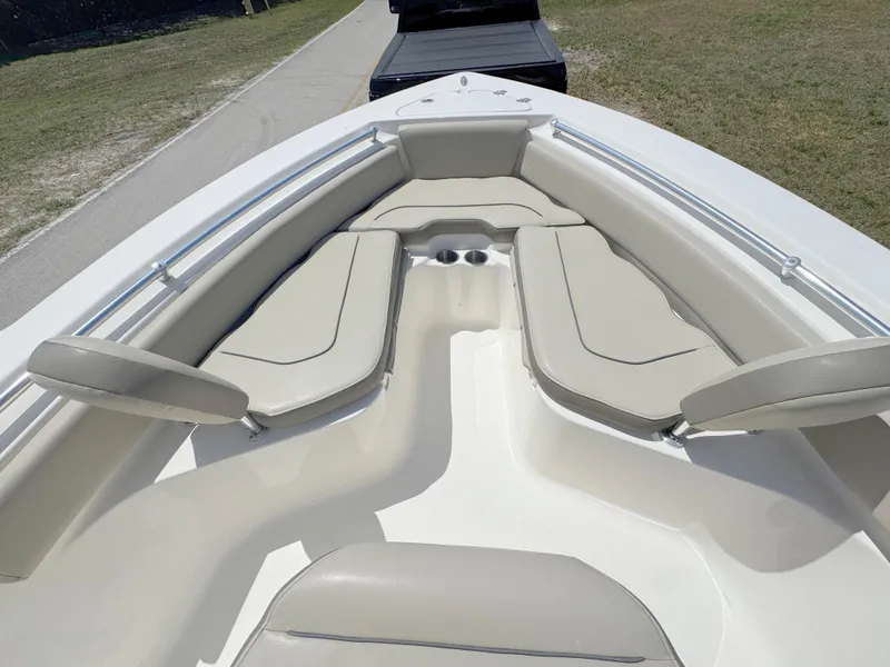 Slide: The Image of 2022 Key West 219 FS boat interior with beige seating and cup holders. - 10