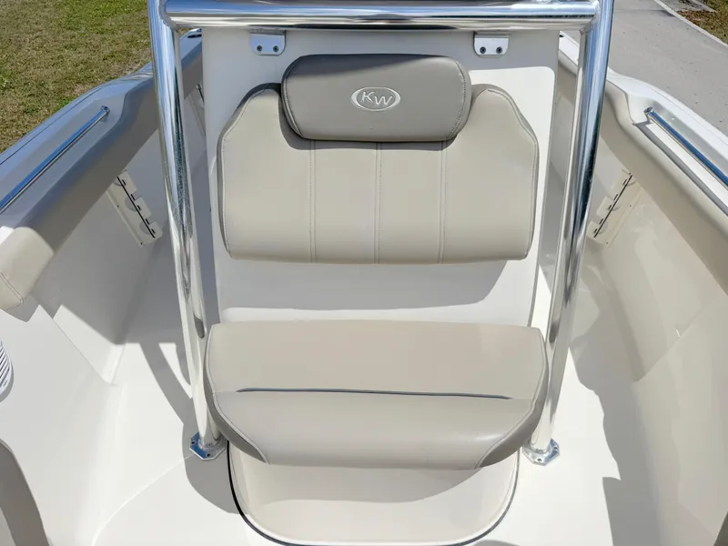 Slide: The Image of 2022 Key West 219 FS boat seat with beige upholstery and chrome accents. - 12