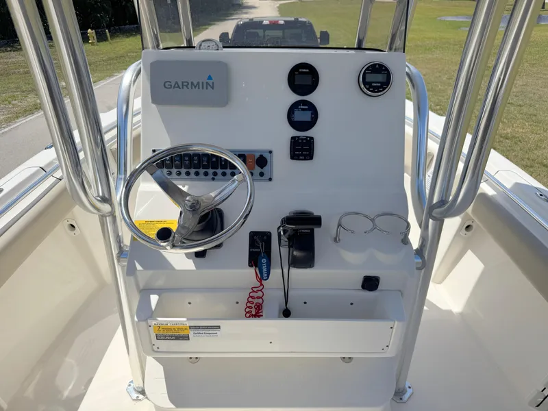 Slide: The Image of 2022 Key West 219 FS boat console with Garmin navigation system and steering wheel. - 18